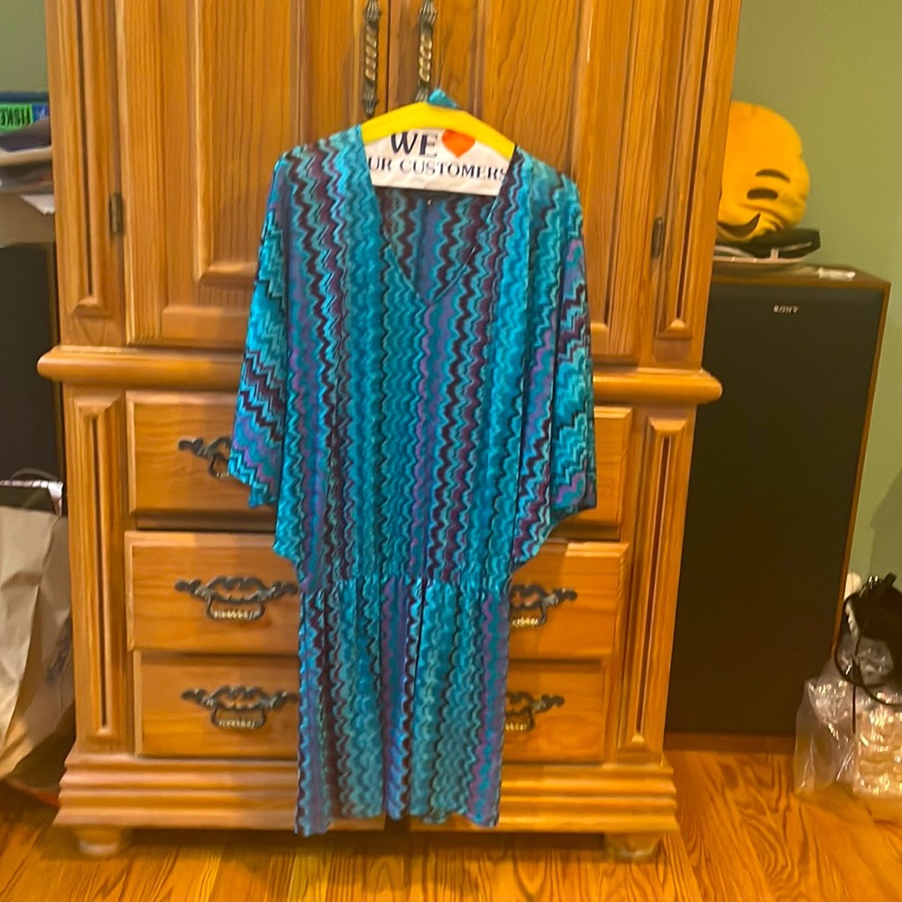 Fun, flirty mini dress!  V-neck, cool pattern, lightweight material